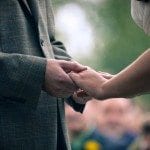 Bride and groom hold hands at the alter during wedding ceremony in Nashville Tennessee