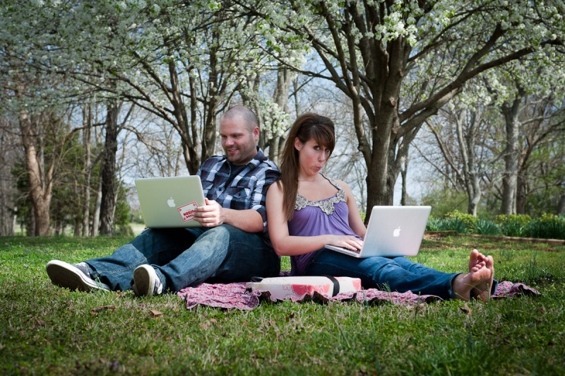 Couple Sitting in Grass With laptop | Nashville Photographers Engagement