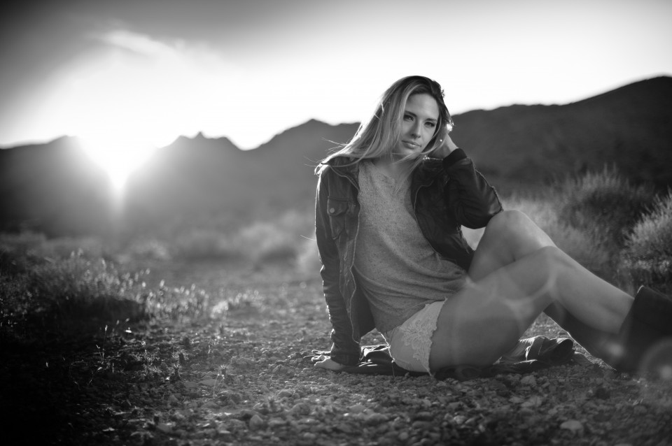 beautiful blonde sitting in the desert in nevada black and white portrait