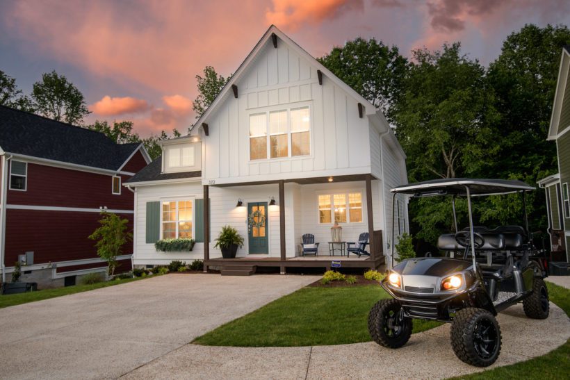 Sunset or Twilight Photo of White House with glowing windows and golfcart in front
