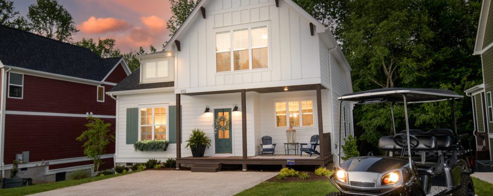 Sunset or Twilight Photo of White House with glowing windows and golfcart in front