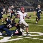 MBA football player runs the ball and tries to break a tackle in Tennessee