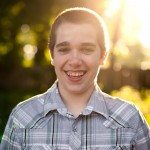 young boy smiles in sunny yard in Tennessee