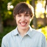 teen boy smiles outside in sunny yard in Tennessee