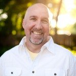 Man in white shirt smiles outside in Tennessee