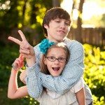 Brother and Sister show peace sign outside in yard in Tennessee