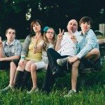 Family sitting on bench showing peace sign in Tennessee