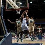 Belmont basketball player jumps for the basket with defenders all around in Tennessee