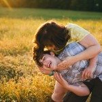 son and mother laughing in sunny field in Tennessee