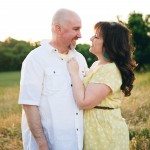 Man and Woman in sunny field smile at each other in Tennessee