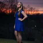 blonde girl in blue dress looks at sky at sunset in Tennessee