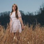 smiling girl in white dress in sunny field in Tennessee
