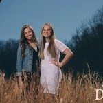 girls smiling together outside in field in Tennessee