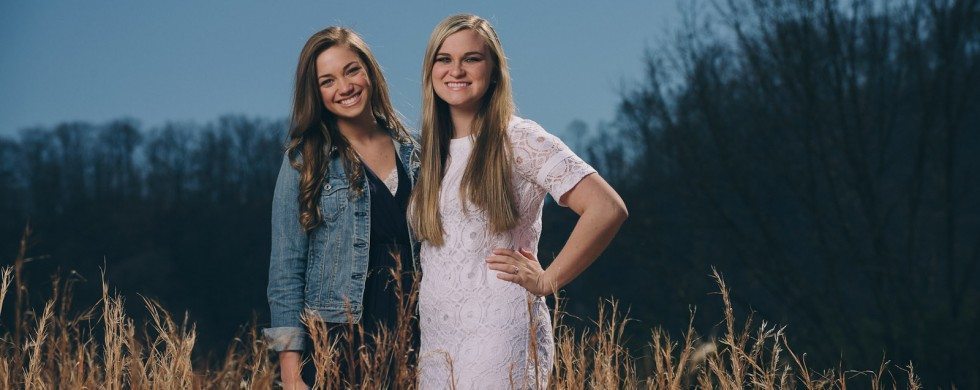 girls smiling together outside in field in Tennessee