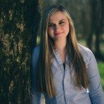 smiling blonde girl leaning on tree in Tennessee