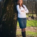 smiling girl in cowboy boots leaning on tree in Tennessee