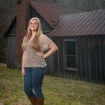 smiling blonde girl standing in front of an old house in Tennessee
