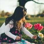 child puts flowers in the ground in Tennessee