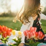 Child getting up from blanket outside with flowers in Tennessee