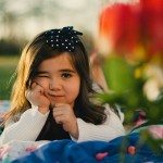 daughter on blanket outside with bow in hair in Tennessee