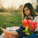 child looks down sitting on blanket outside in Tennessee