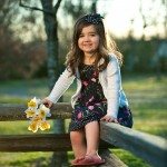 Child smiles and sits on old fence in Tennessee