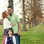 Wife kissing husband while daughter looks on outside in Tennessee