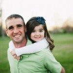 Father and daughter smile together outside in Tennessee