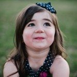 child smiles and looks at the sky in yard in Tennessee