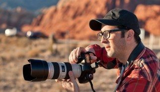man with big camera in nevada redrocks