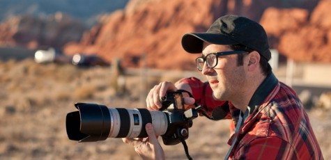 man with big camera in nevada redrocks