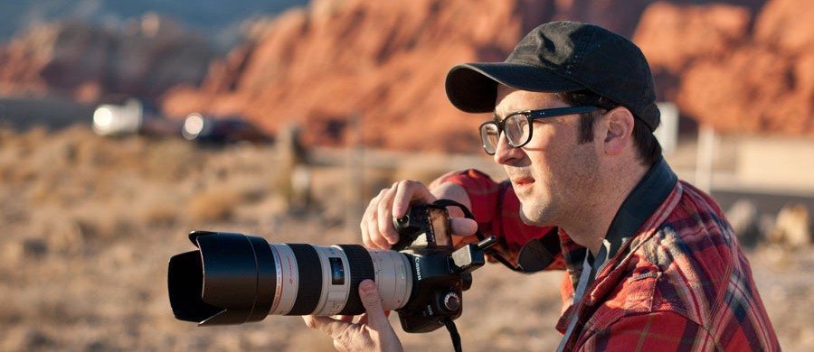 man with big camera in nevada redrocks