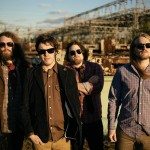 Band members in sun glasses in industrial landscape for band portrait in Nashville Tennessee