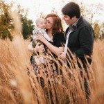 Mother kisses baby in amber field for family portrait in Nashville Tennessee