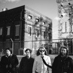 Black and white of band members standing in industrial area for portrait in Nashville Tennessee