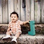 Cute baby holds toy and sits on stone steps for portrait in Nashville Tennessee