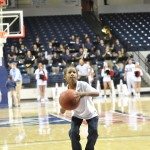 child in white shirt takes a shot on the basketball court in Tennessee