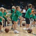 Children practice dribbling the basketball on the court in Tennessee