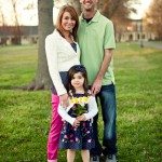 Family smiles outside while daughter holds flowers in Tennessee
