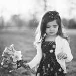 daughter walks with flowers through field in Tennessee