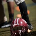 A battered football helmet rests on the field during game in Tennessee