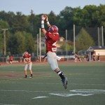 Football player leaps into the air to catch football in Tennessee