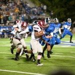 MBA football player run the football down the field in Tennessee