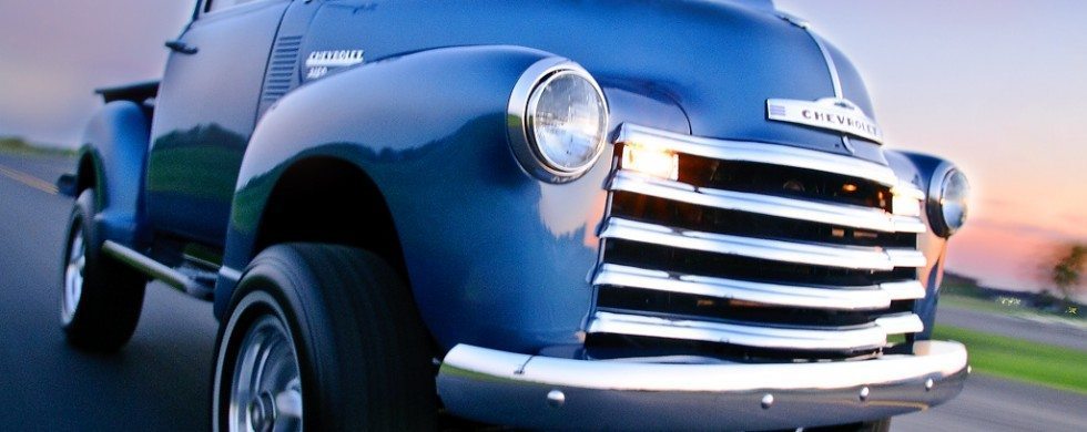 Classic blue Chevrolet truck driving down the run at sunset in Tennessee